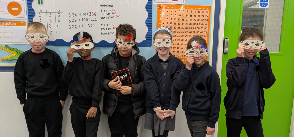 Children wearing fun French masks in class